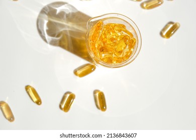 Fish Oil Gelatin Capsules In Laboratory Flasks On A White Background.Healthy Eating And Food Supplements.omega Fatty Acids.