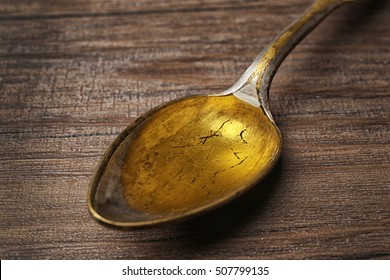 Fish Oil In Spoon On Wooden Background