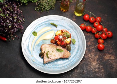 Fish Pan With Vegetable Ratatouille. A Plate With An Appetizing Dish. Application Suggestion. Culinary Photography, Food Stylization.