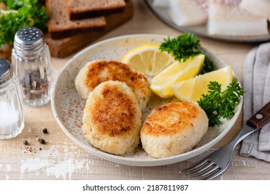 Fish patties or fish cakes on plate. Fried white fish cutlets or patties