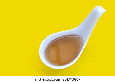 Fish Sauce In Spoon On Yellow Background