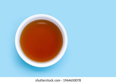 Fish Sauce In White Bowl On Blue Background.