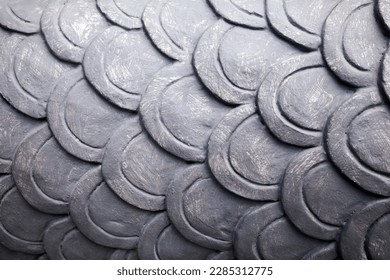 Fish scales pattern painted gray color background. Cement wall decoration architecture detail. Dragon sculpture skin close-up - Powered by Shutterstock