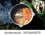 fish soup in a cauldron over a fire. Hiking, fishing concept. camping, recreation