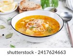Fish soup with salmon, vegetables and rice in white bowl. Salmon soup.
