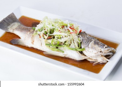 Fish In Soy Sauce, Served On White Plate 