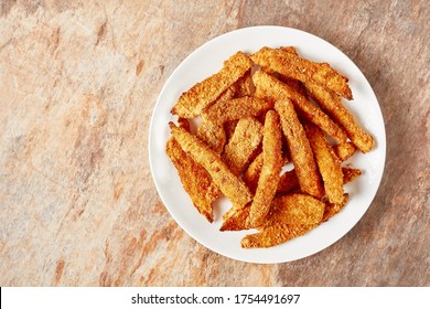 Fish Sticks, Fish Fillet Fingers Breaded And Deep-fried Served On A White Plate On A Ceramic Kitchen Table, Horizontal View From Above, Flat Lay Free Space