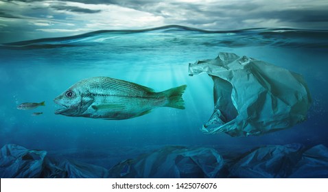 Fish swims among plastic bag ocean pollution. Environment concept