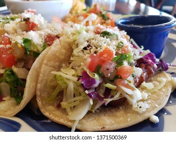 Fish Tacos With Cabbage , Pickled Red Onion And Pico De Gallo Topped With Some Queso Fresco. Soft Warm Corn Tortillas.