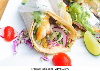 Fish Tacos On White Plate With Cherry Tomatoes