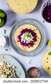 Fish Tacos Ready For Serving Top View With Purple Cabbage Salsa, Mexican Crema With Lime And Sour Cream On Flour Tortilla And Marinated Sea Bass Fish In Lime