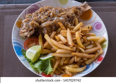 Fish With Yassa Sauce And Chips At A Restaurant On Goree Island, Dakar, Senegal