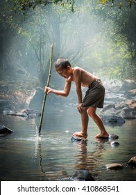 Fisher Boy Hunter Fishing Gaff On The Creek Forest.