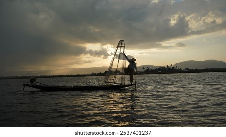 Fisherman Balancing on Boat at Inle Lake, Myanmar at Sundown - Powered by Shutterstock