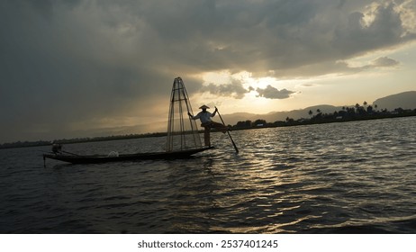 Fisherman Balancing on Boat at Inle Lake, Myanmar at Sundown - Powered by Shutterstock