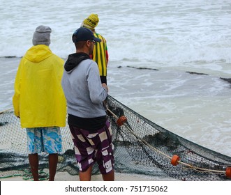 Fisherman at the beach pulling in nets