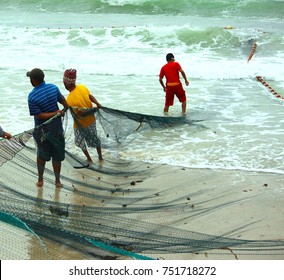 Fisherman at the beach pulling in nets