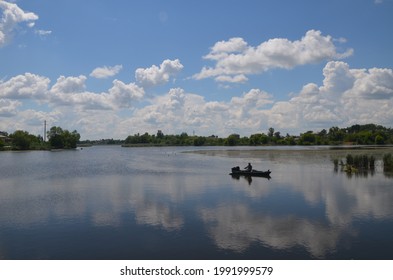 Fisherman In A Boat On The River Sluch