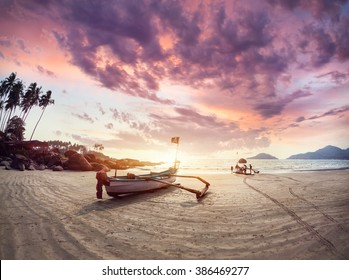 Fisherman boat on the tropical beach at sunset of Dreamy Palolem beach in Goa, India