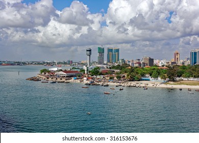 Fisherman Boats In Front Of Kivukoni Fish Market With Port Control Tower And Skyscrapers Behind, Dar Es Salaam, Tanzania