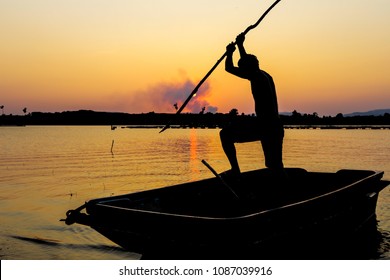 Fisherman Catching The Fish By Spear In Silhouette Picture Style