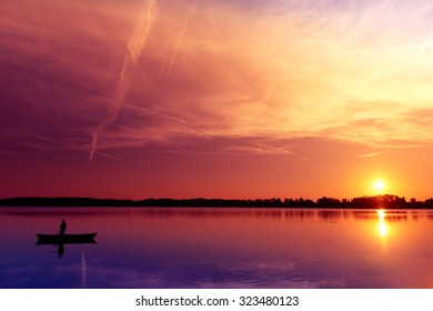 Fisherman Catching Fish At Sunset. Masuria, Poland.