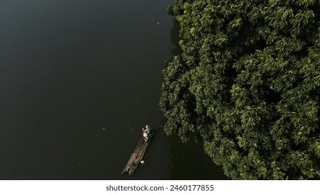 
Fisherman checking fish trap nets in small lake