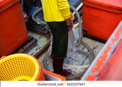 Fisherman cleaning his body after cleaning fishing boat