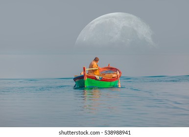 A fisherman departs Urla Harbor on the Mediterranean sea in izmir at dusk as a full moon is rising. 