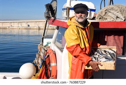 fisherman with a fish box inside a fishing boat - Shutterstock ID 763887229
