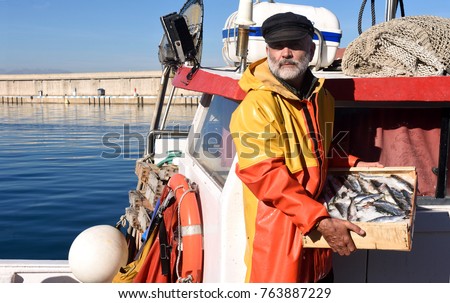 fisherman with a fish box inside a fishing boat