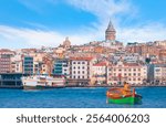 Fisherman with fishing boat in a calm sea -  - Galata Tower, Galata Bridge, Karakoy district and Golden Horn at morning, istanbul - Turkey