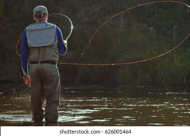 A fisherman fishing with fly fishing. Beautiful cord rings when casting Circle Castes, Voodoo Castes