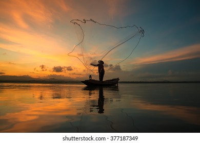 Fisherman fishing at lake in Morning, Thailand. 