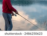 fisherman fishing with rod at the lake.