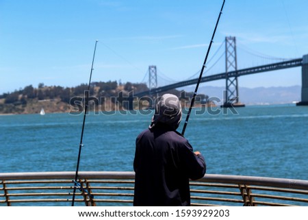 Fisherman with fishing rods near the White Bridge between San Francisco and Auckland in California