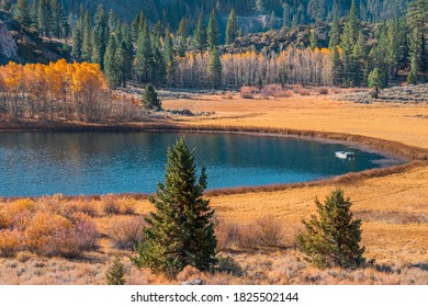 Fisherman Floats On Gull Lake In The Autumn Morning In The June Lake Loop Of California.