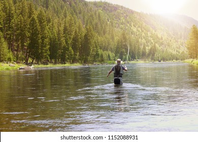 Fisherman Flyfishing In River Of Montana State