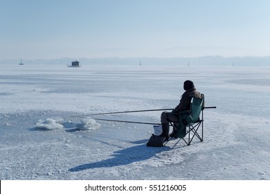 fisherman and frozen lake - Powered by Shutterstock