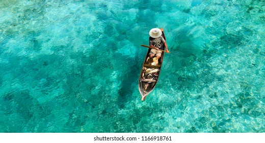 Fisherman in his boat  on turquoise sea