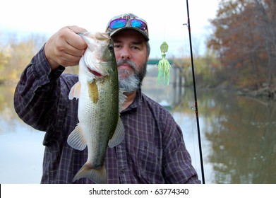 Fisherman Holding A Large Mouth Bass Closeup