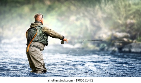 Fisherman hunting trouts in mountain river. Fishing net detail.