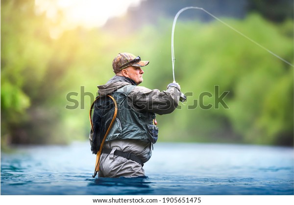 Fisherman hunting trouts in mountain river.\
Fishing net detail.
