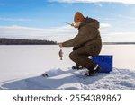  Fisherman at ice winter fishing. Ice fishing