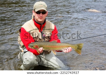 fisherman with a large steelhead caught on the Salmon RIver, near Sun Valley, Idaho