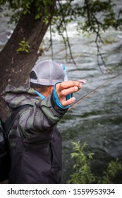 Fisherman Making A Bow And Arrow Cast With Fly Fishing.