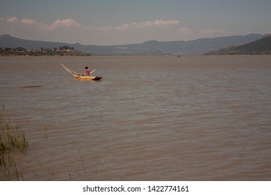 Fisherman Man Moving His Raft To Be Able To Fish In The Lake Of Pátzcuaro Mexico