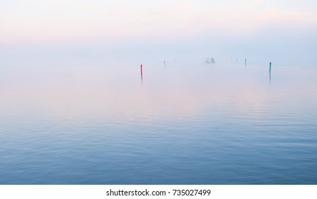 Fisherman in the morning fog on Burt Lake, MI.