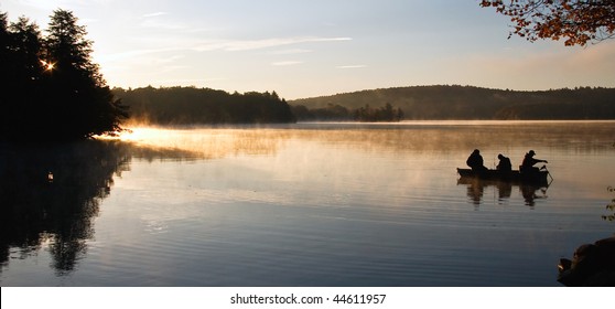 Fisherman on Lake at First Light - Powered by Shutterstock