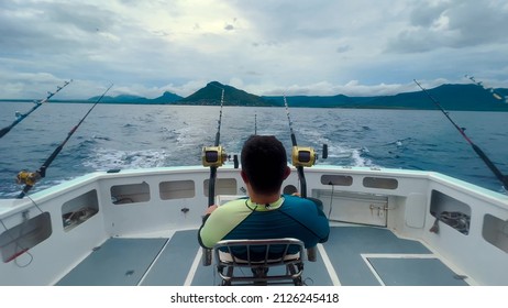 A fisherman on a motorboat catches a big fish of marlin and tuna. Big game fishing reels and rods reels and rods